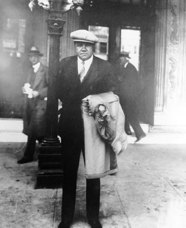 a man in a suit holding a coat