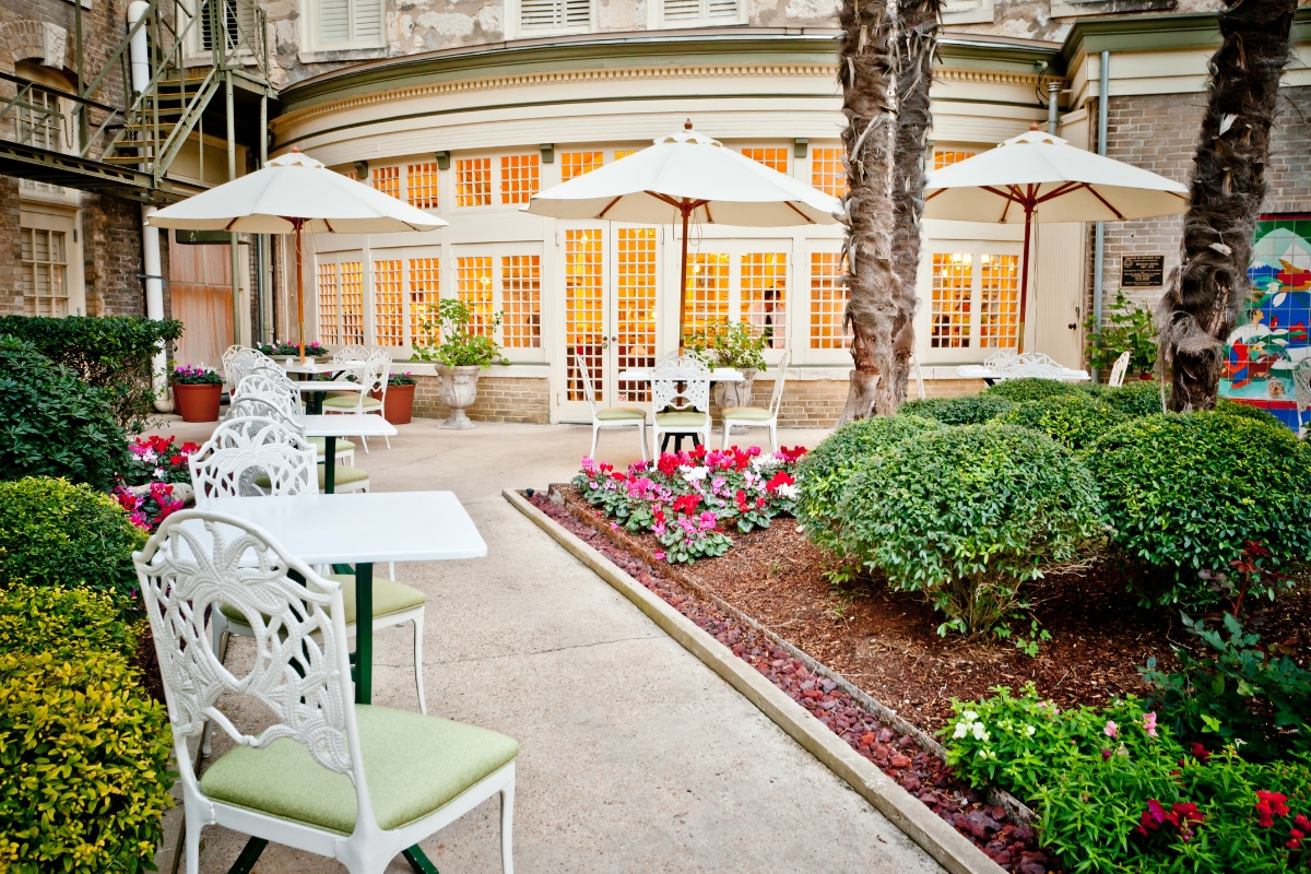a patio with tables and umbrellas