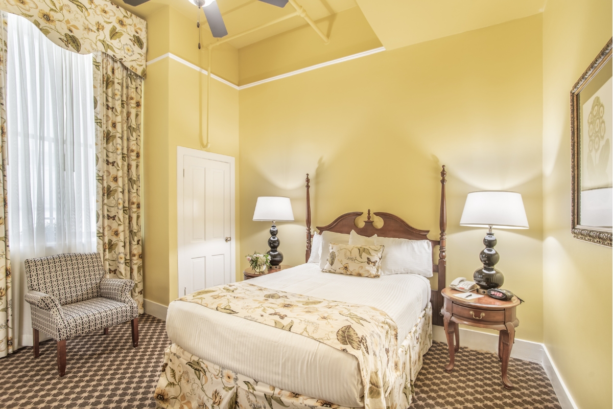 a room with a bed and a fan