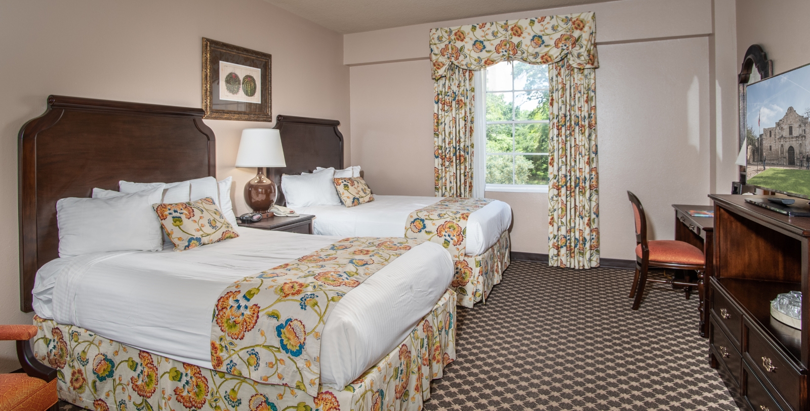 a room with two beds and a window