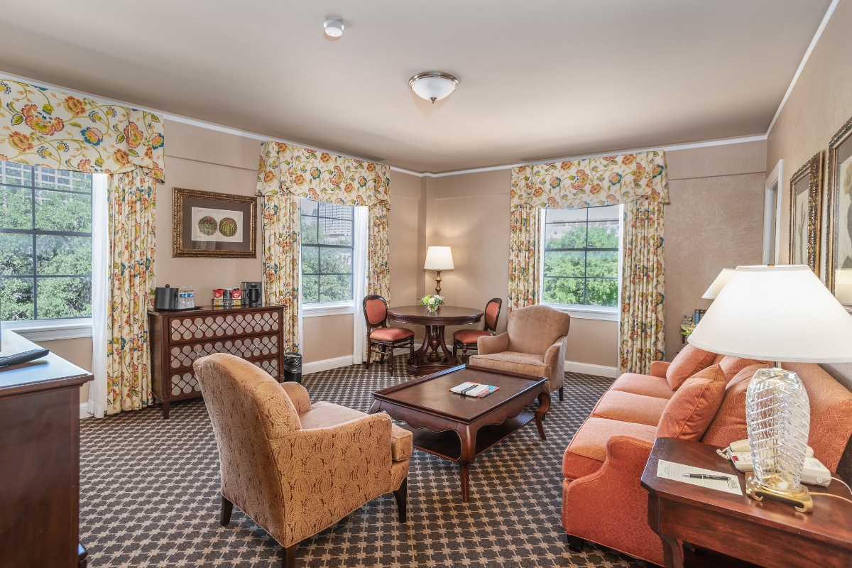 a room with a couch and chairs