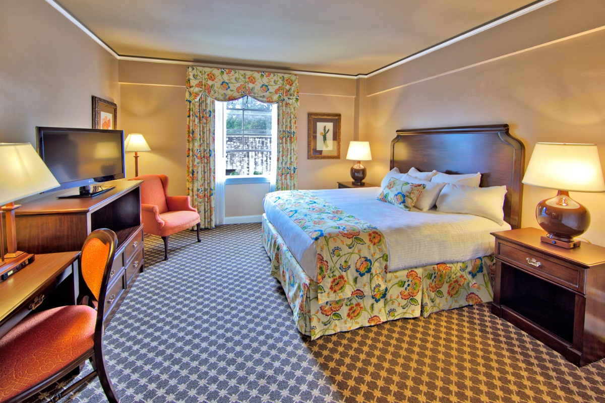 a room with a bed and a television