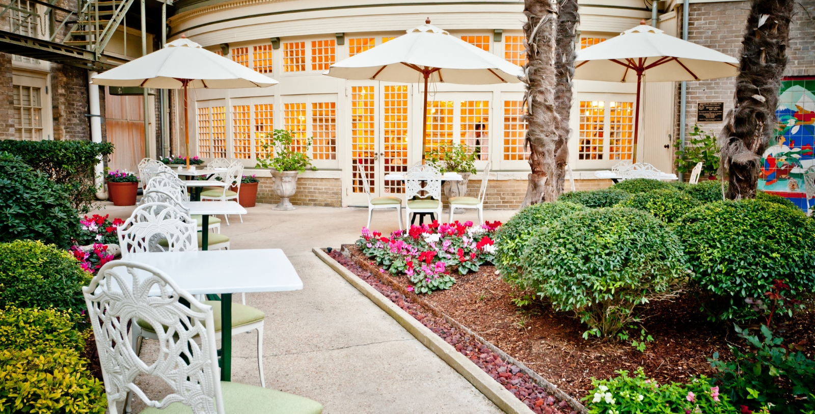 a patio with tables and umbrellas