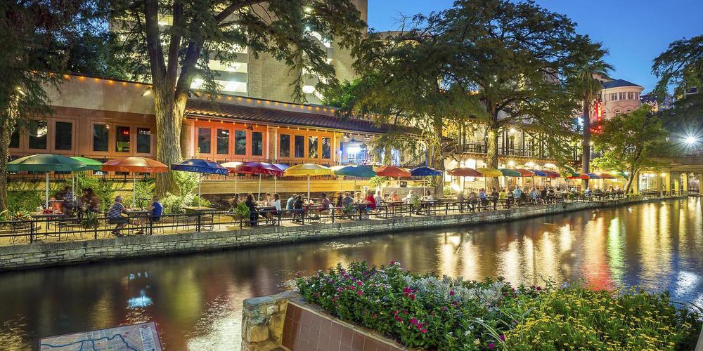 a river with a restaurant and tables