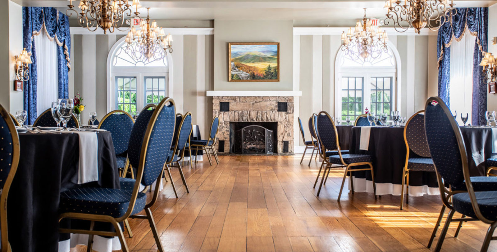 a room with chairs and chandeliers