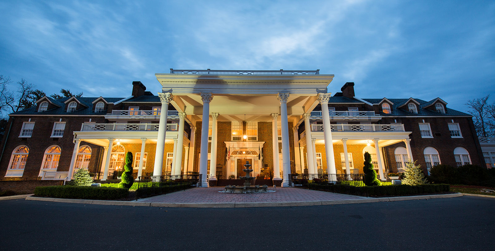 a building with columns and a fountain
