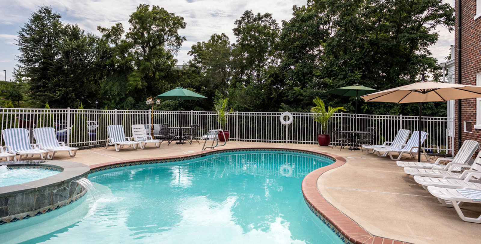 a pool with chairs and umbrellas