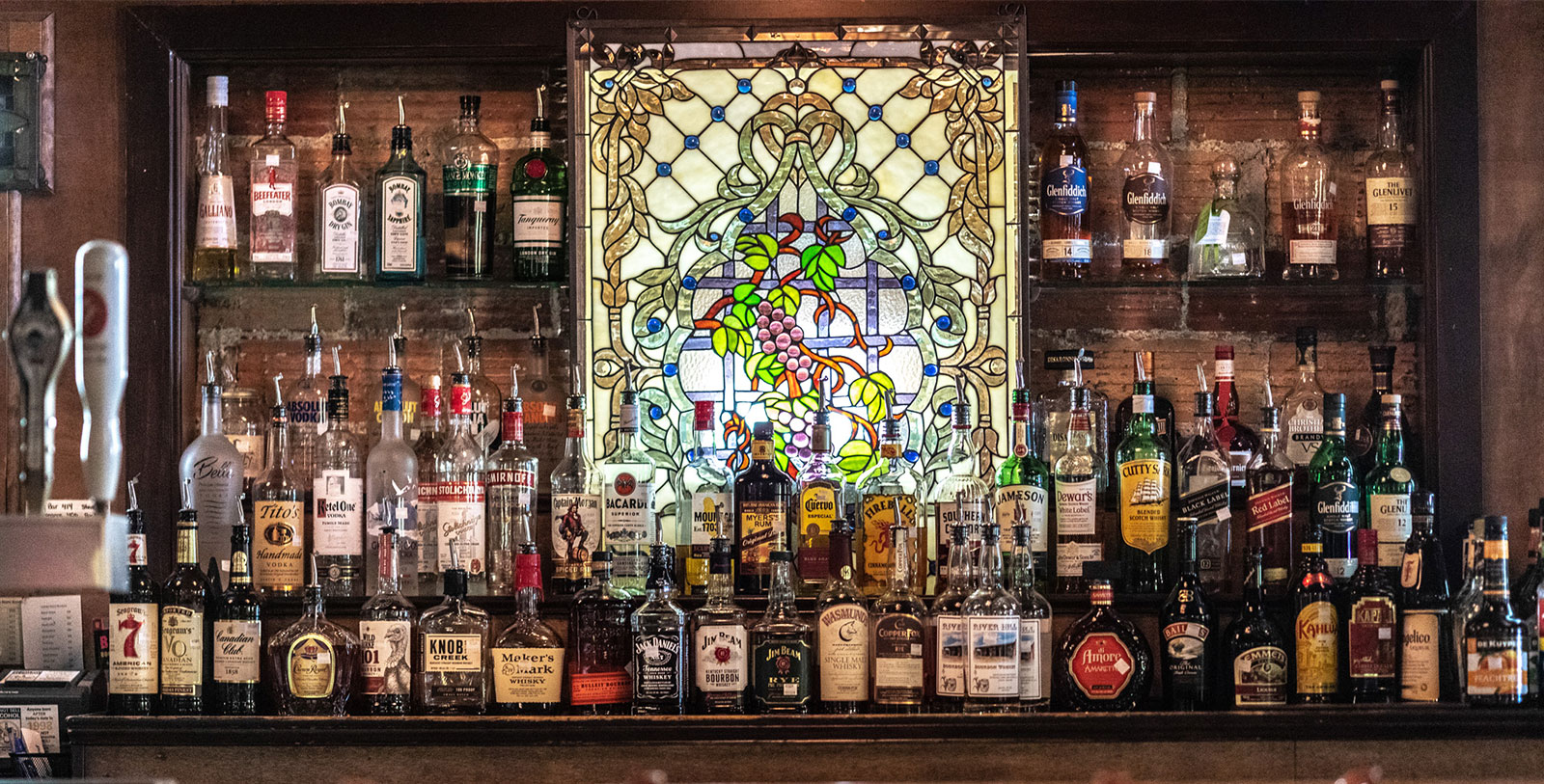 a shelf with bottles of alcohol