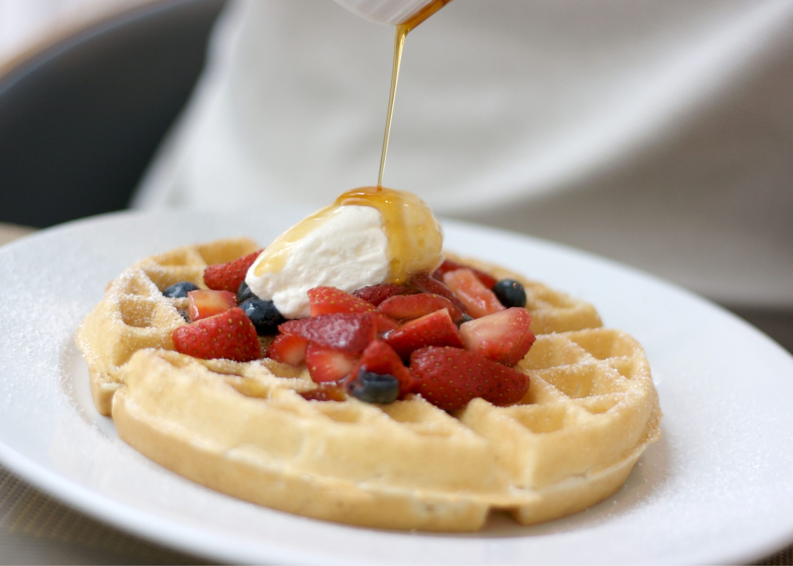 a waffle with strawberries and blueberries on top