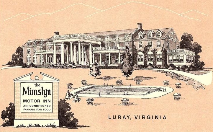 a large building with a pool and a sign