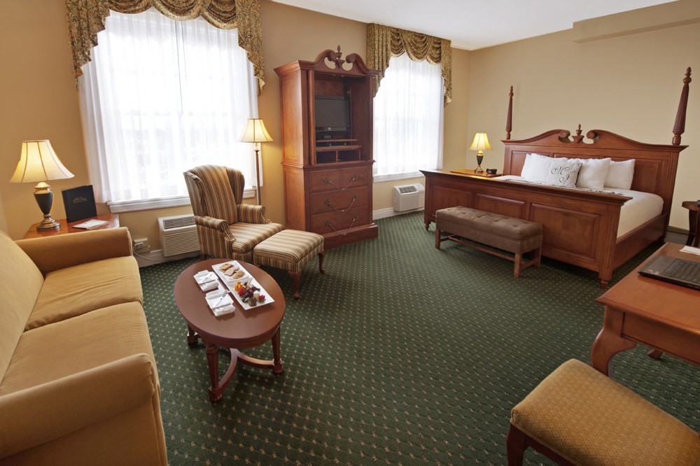 a room with a bed and a television