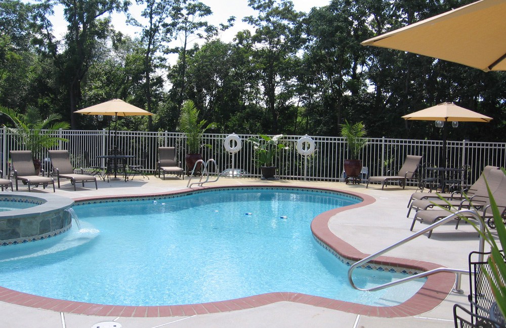a swimming pool with umbrellas and chairs