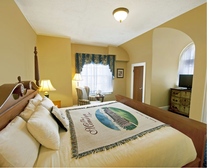 a bedroom with a bed and a tv
