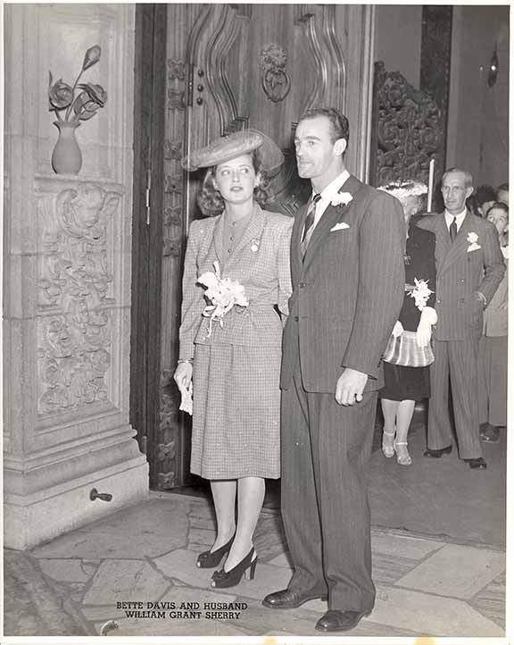 a man and woman standing in front of a door