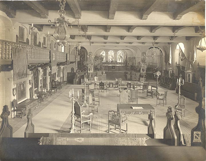 a room with chairs and chandeliers