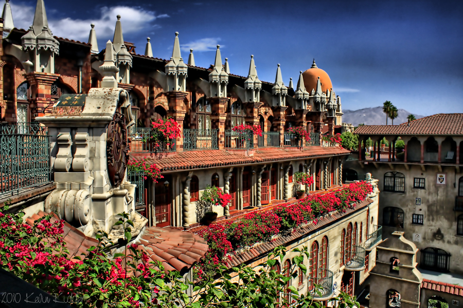 a building with flowers on the balcony