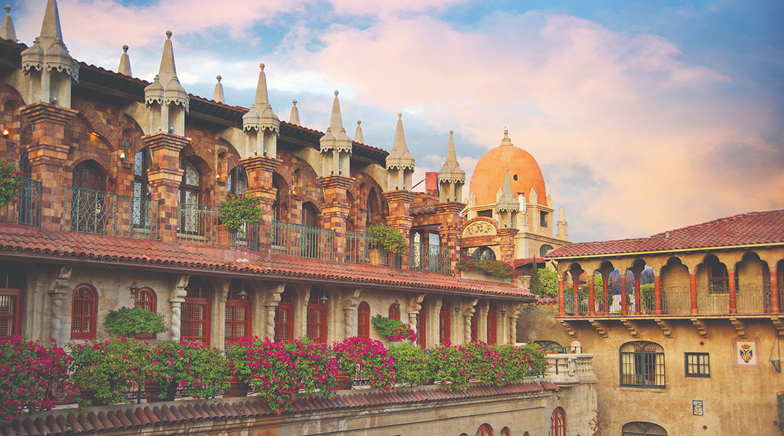 a building with a balcony and flowers