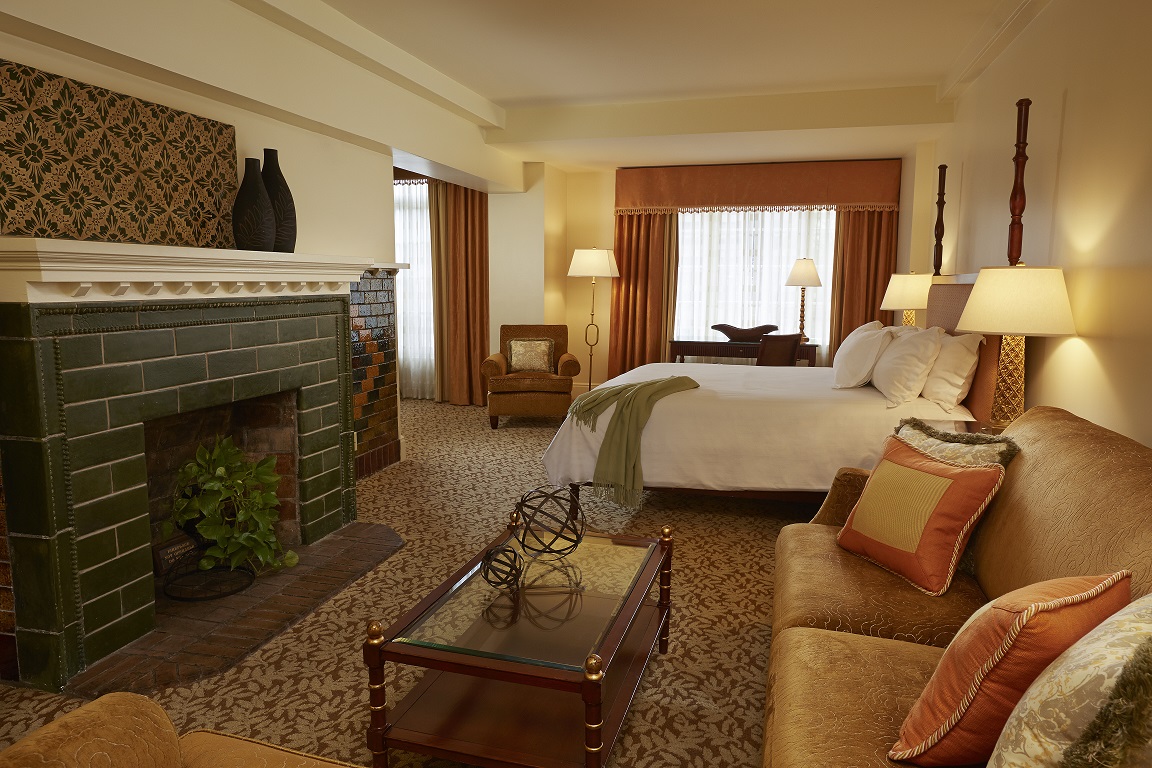 a room with a fireplace and a bed