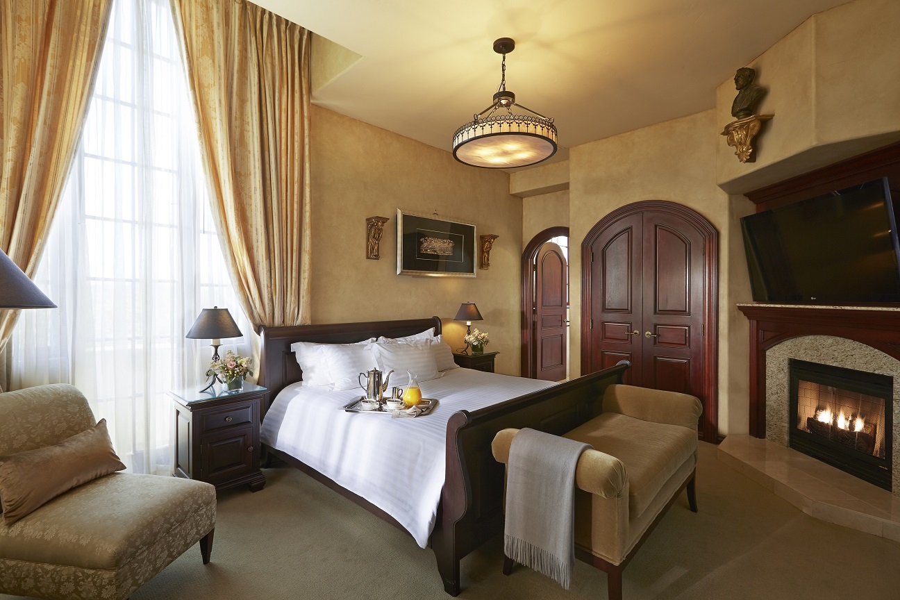 a bedroom with a bed and a chair