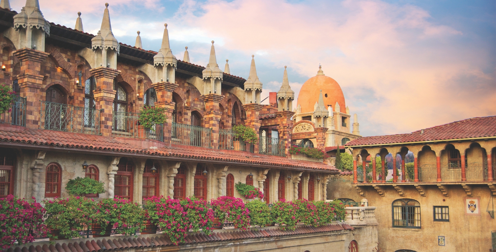 a building with a balcony and flowers