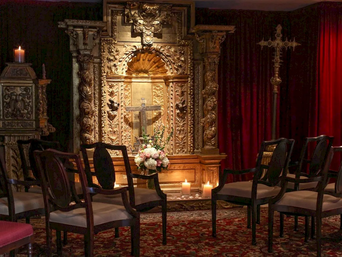 a room with chairs and a cross