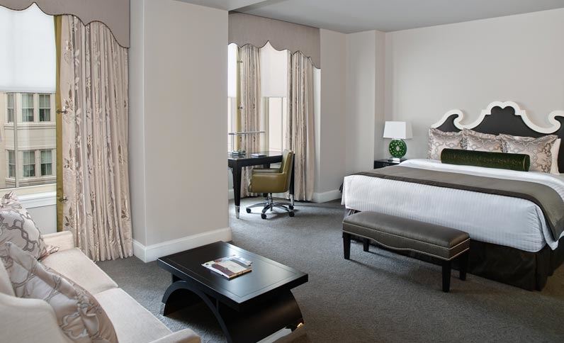 a hotel room with a bed and a table
