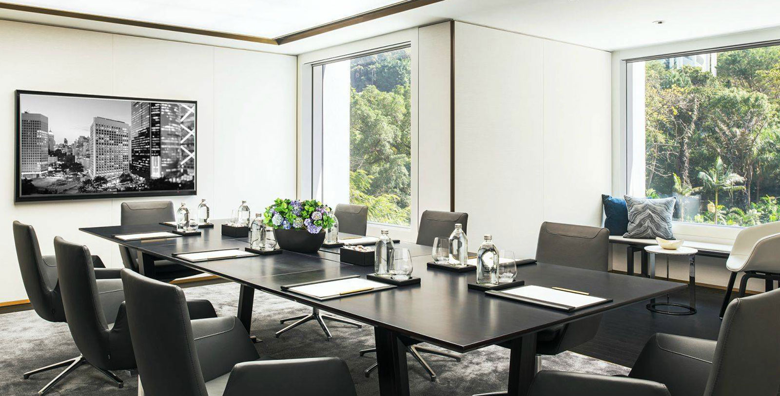 a conference room with a black table and chairs