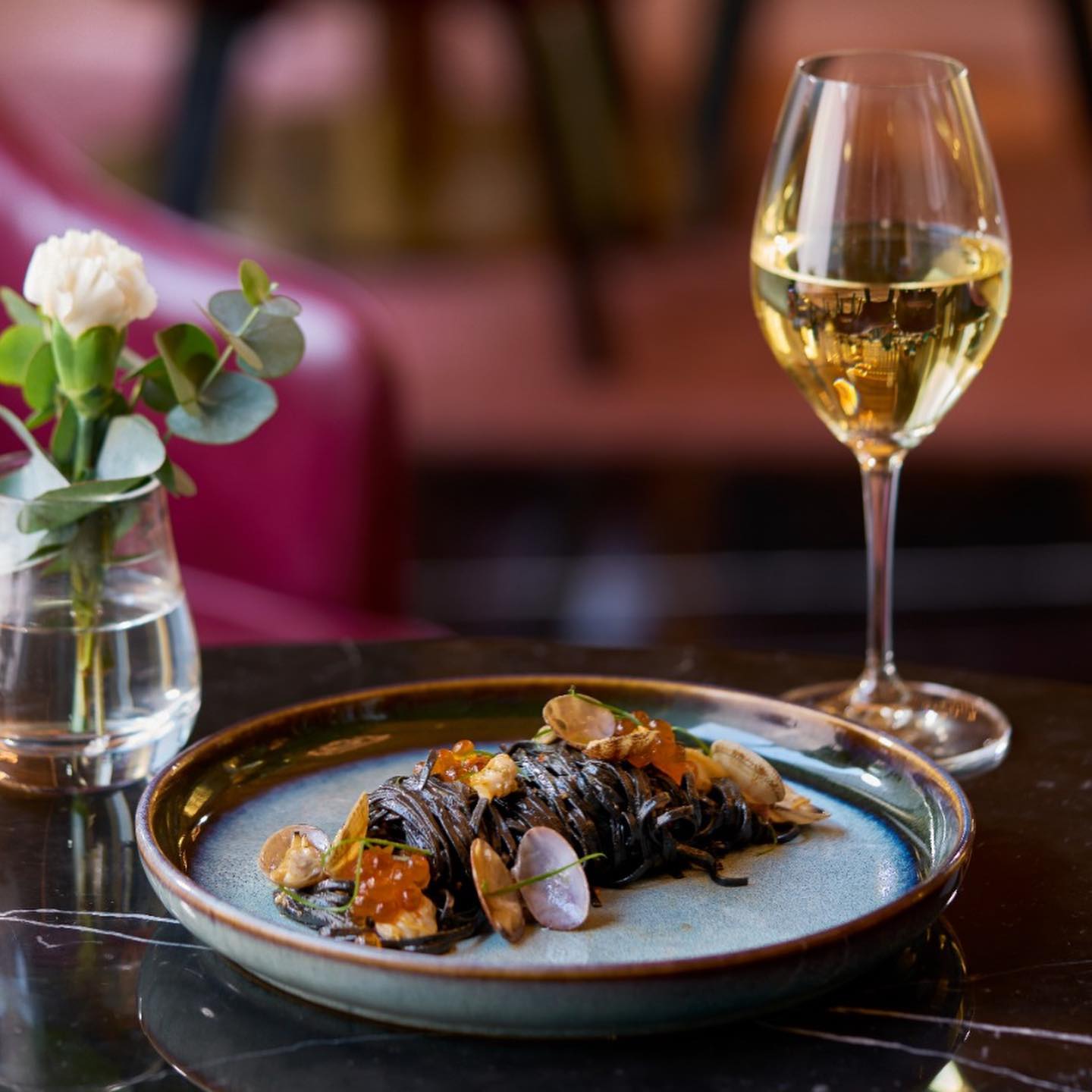a plate of food and a glass of wine