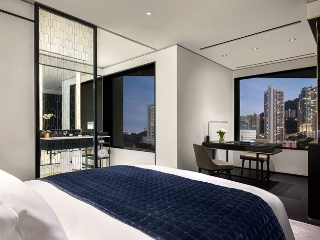 a bedroom with a desk and a table