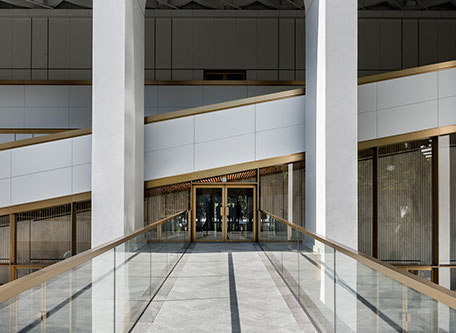 a glass walkway leading to a building