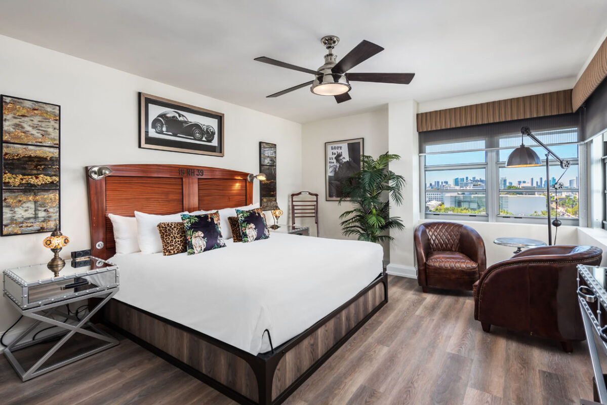 a bedroom with a large bed and a ceiling fan
