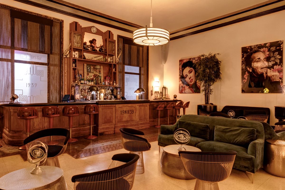 a room with a bar and a green couch