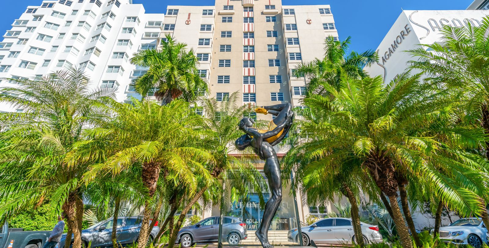 a statue of a man playing a musical instrument in front of a building