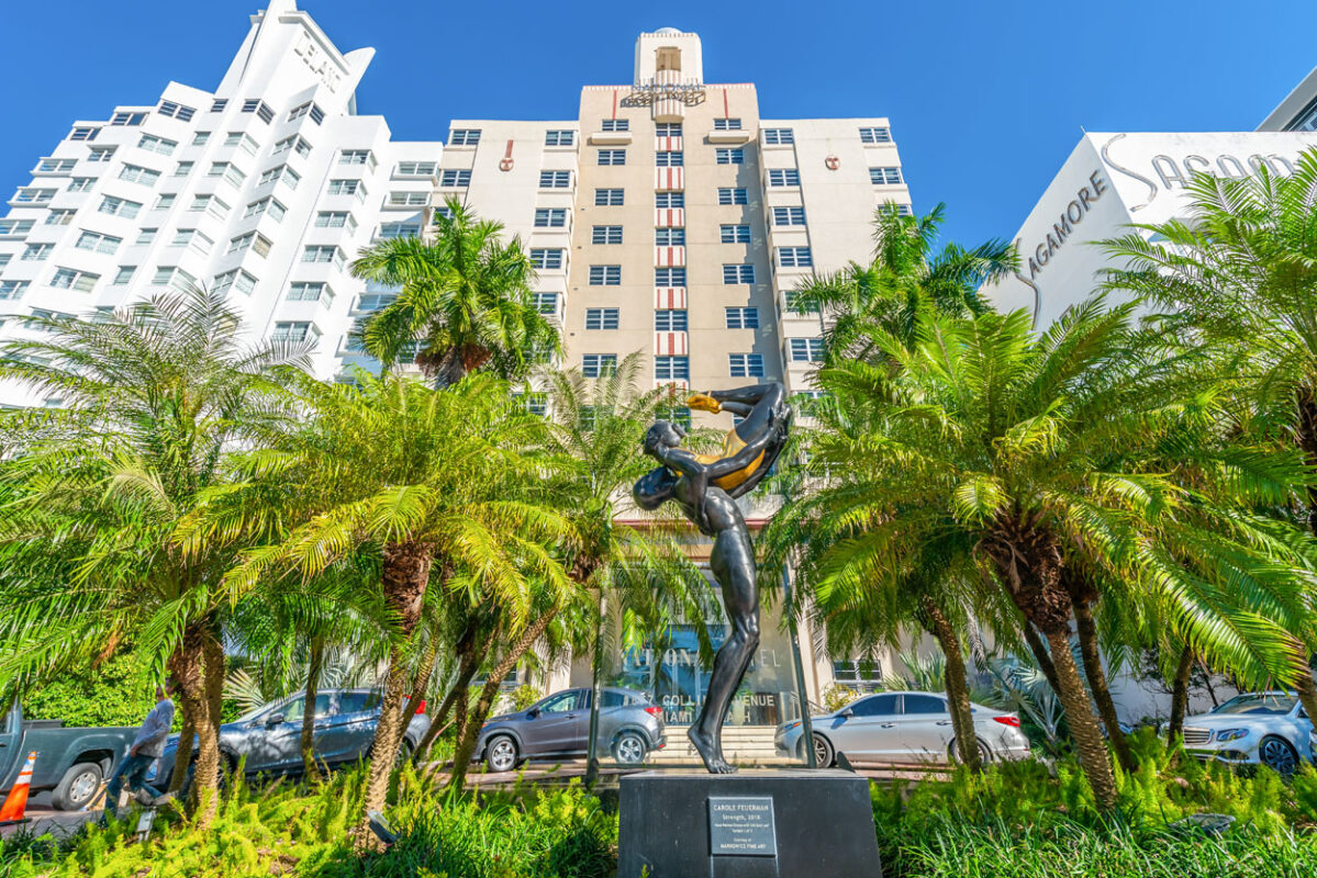 a statue of a woman in front of a building