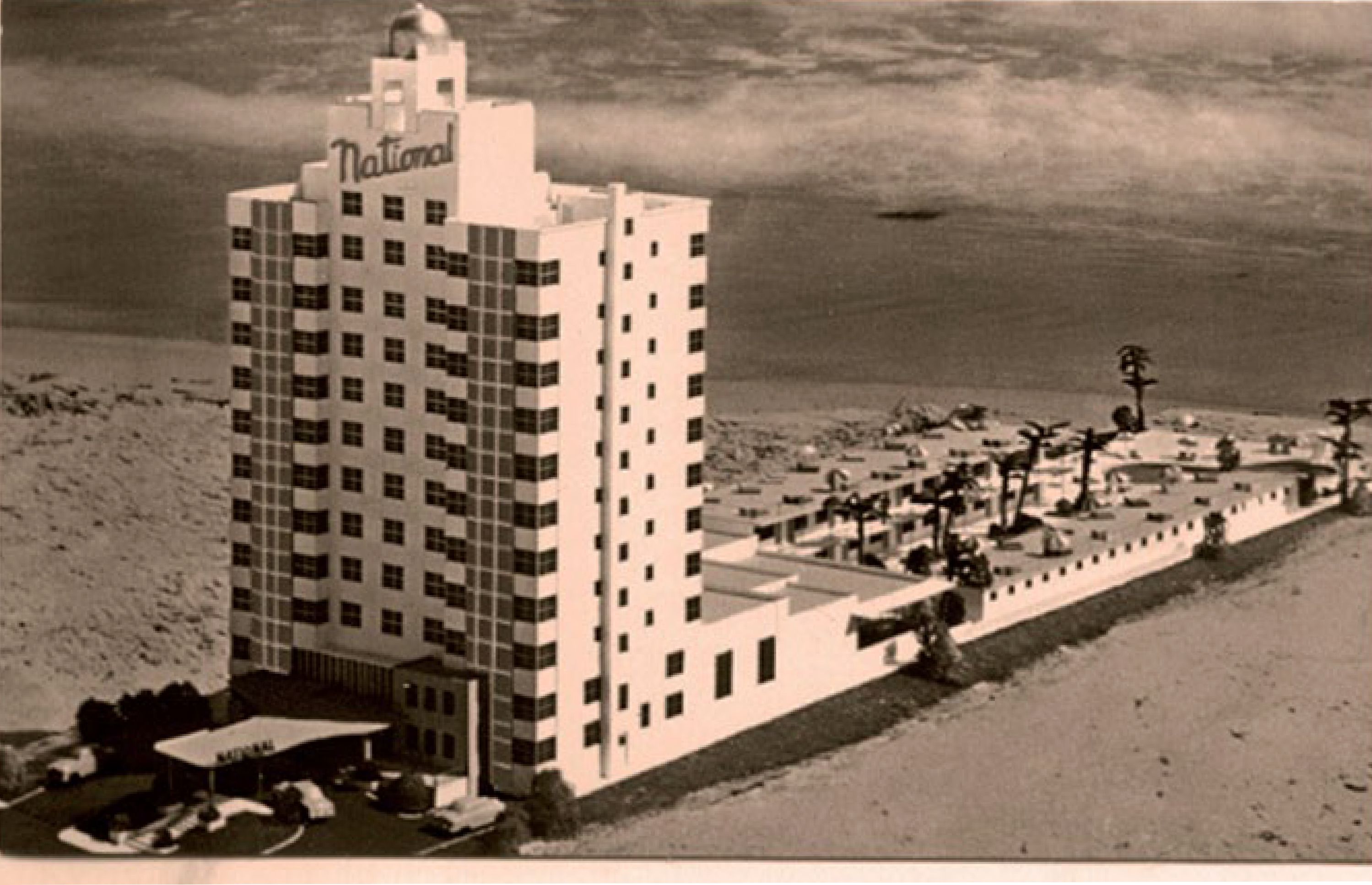 a building with a beach and a lot of cars