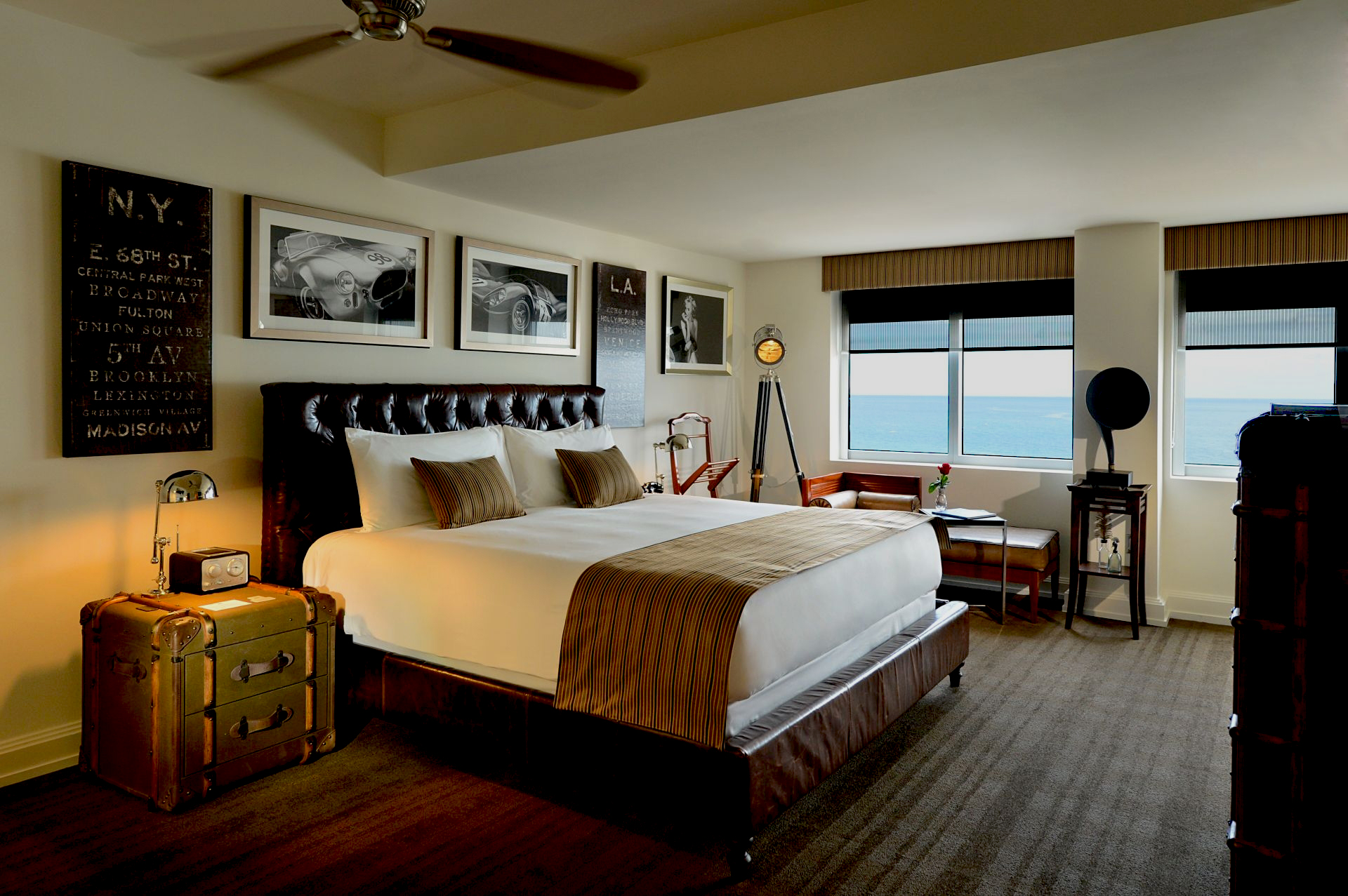 a bedroom with a large bed and a fan