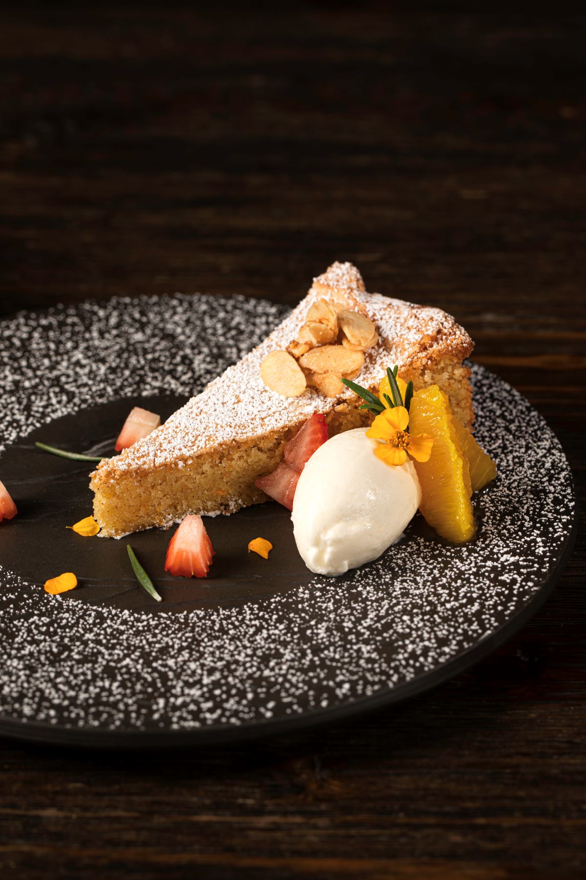 a piece of cake with fruit and ice cream on a plate