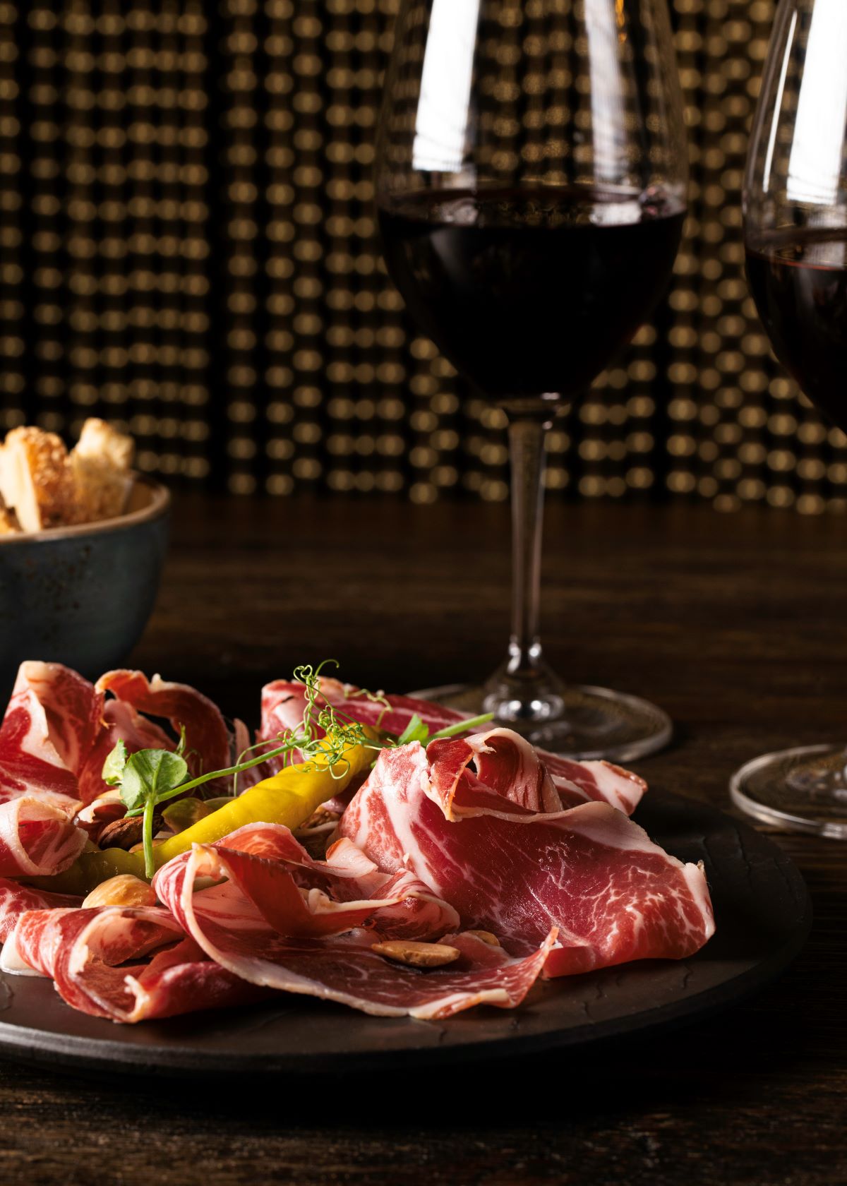 a plate of meat and wine glasses