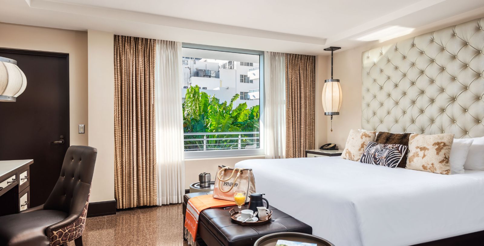 a room with a bed and a table with a coffee table and a window