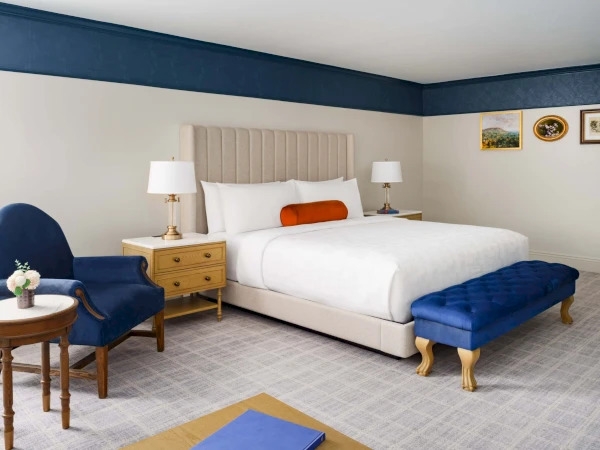 a bedroom with a bed and a chair
