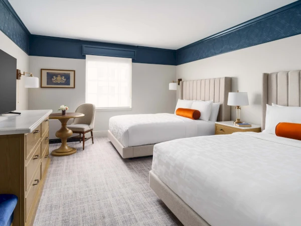a room with two beds and a table