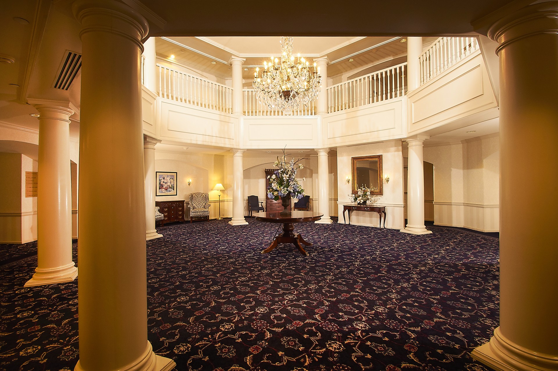 a large room with a chandelier and a table