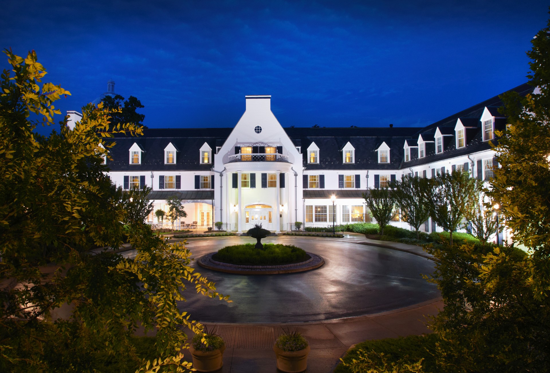 a large white building with a fountain in front of it
