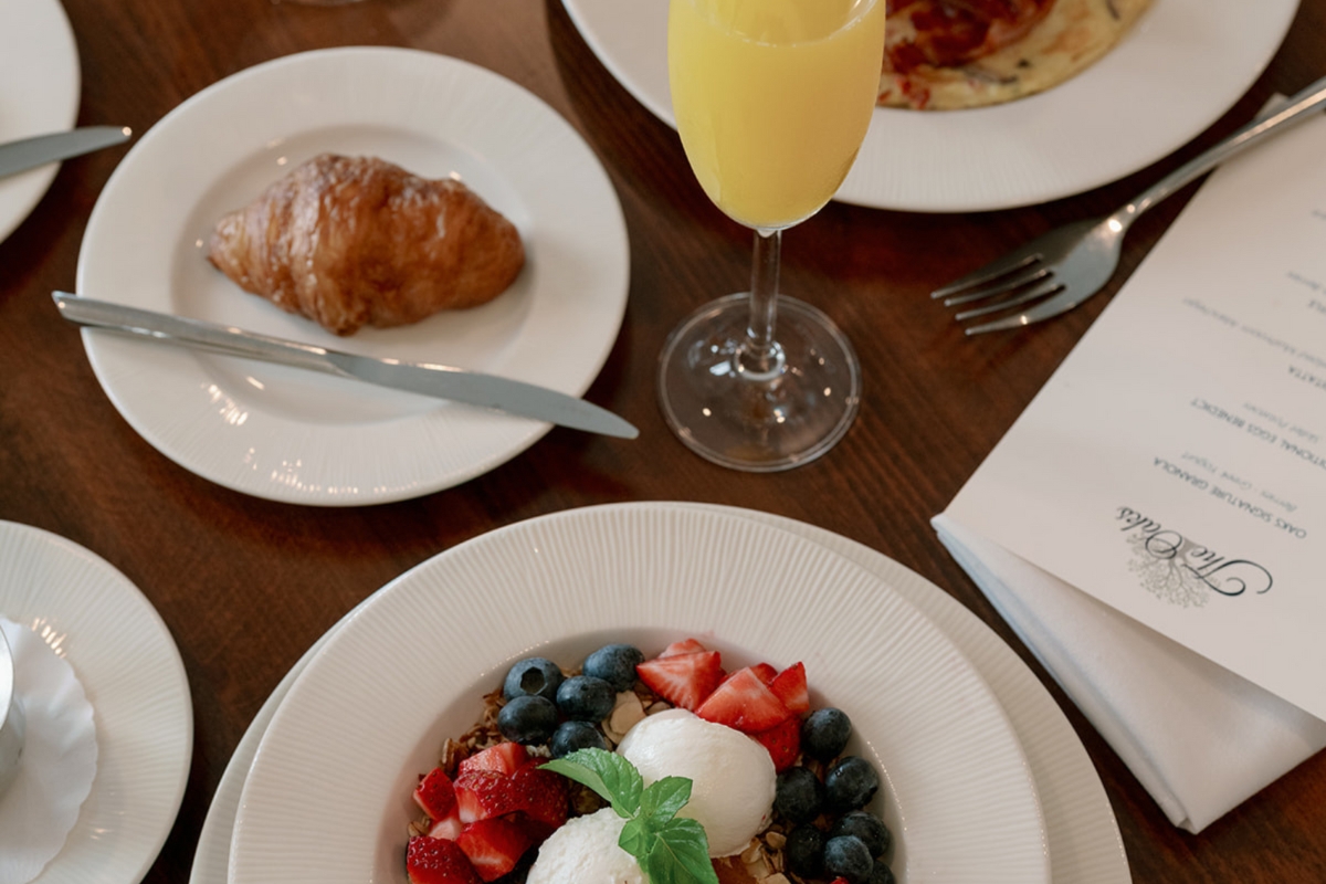 a plate of food and a glass of juice