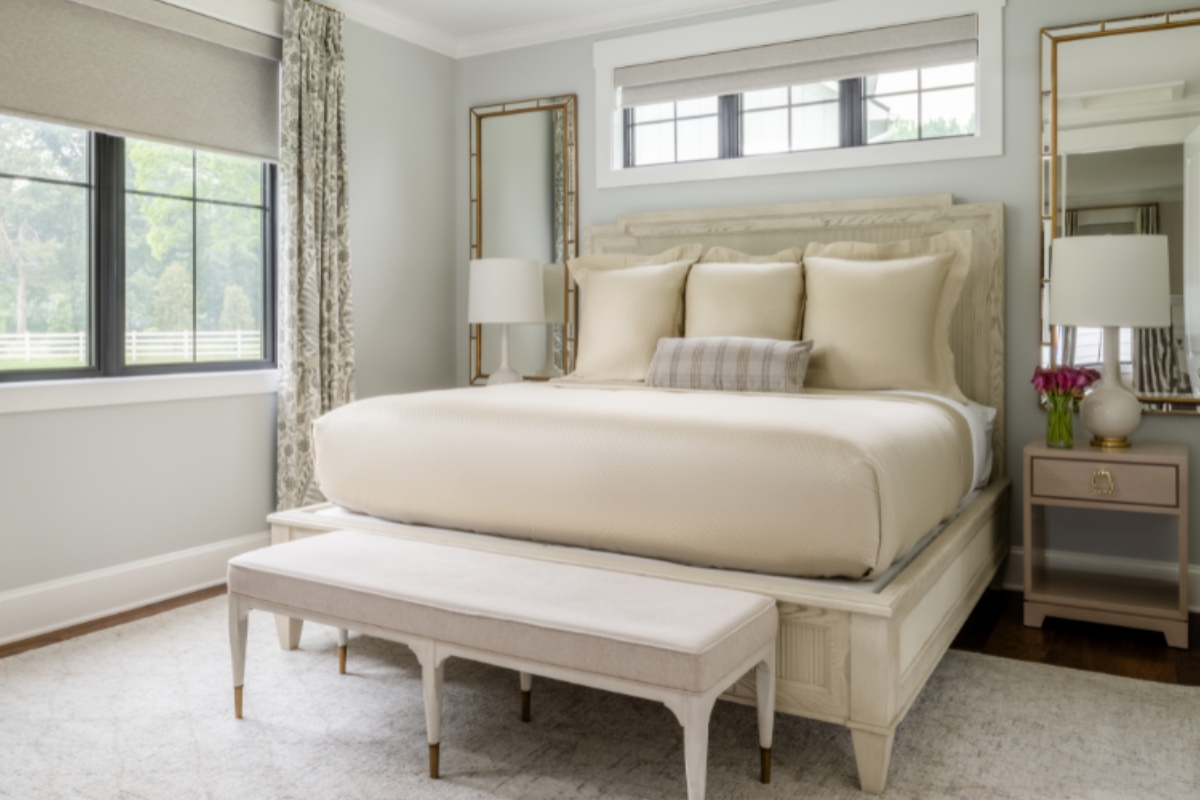 a bed with a bench in a room