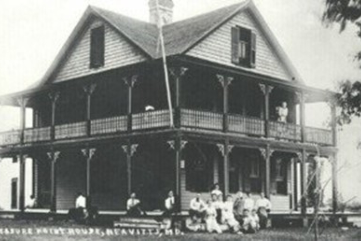 a group of people sitting on a porch of a house