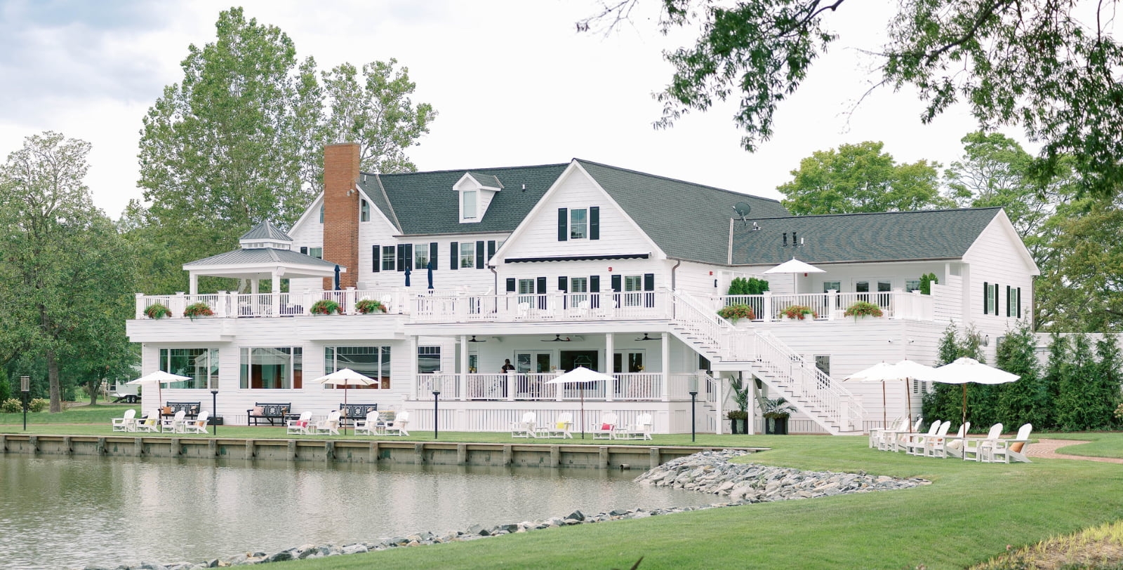 a large white building with a body of water