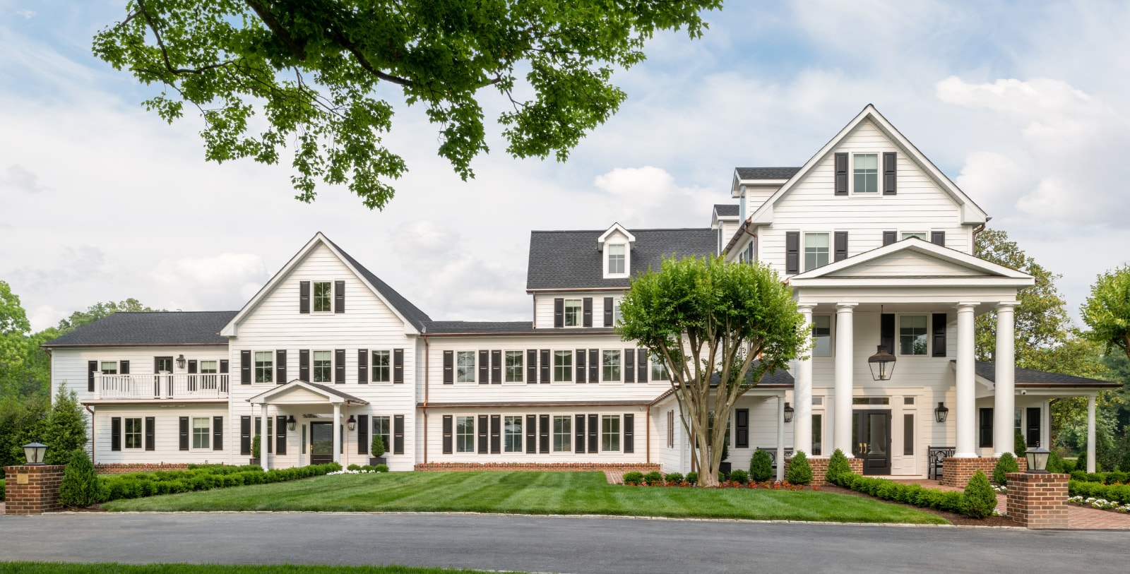 a large white house with a large front yard