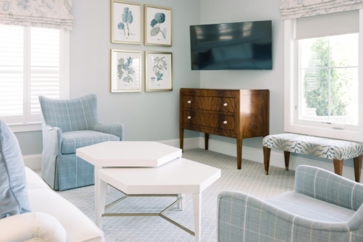 a room with a television and a dresser