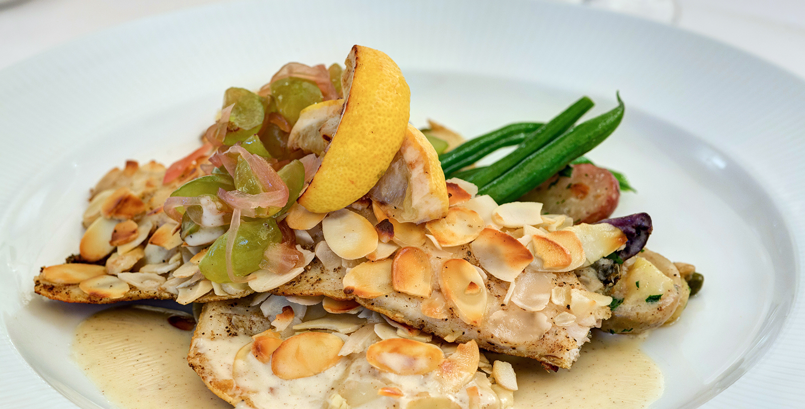 a plate of food with lemons and almonds
